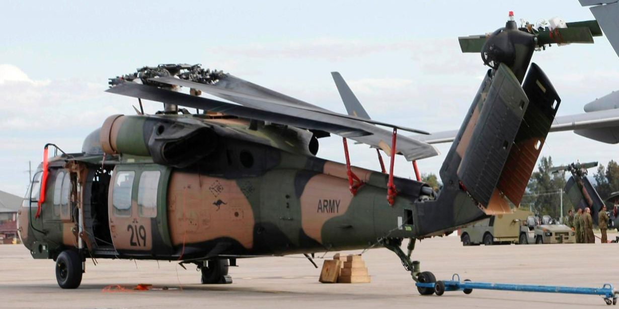 Blackhawk helicopter on tarmac equipped with Davis Aircraft blade fold kit storing the helicopter's blades
