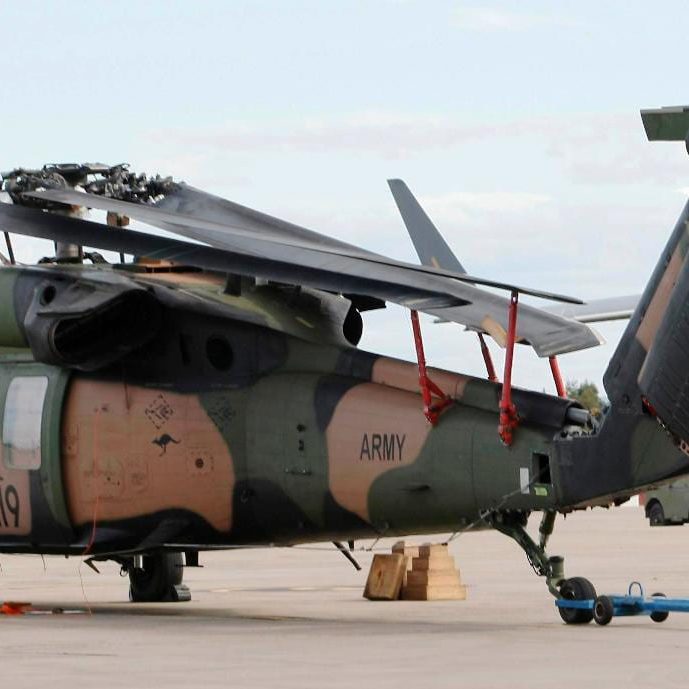 Blackhawk helicopter on tarmac equipped with Davis Aircraft blade fold kit storing the helicopter's blades