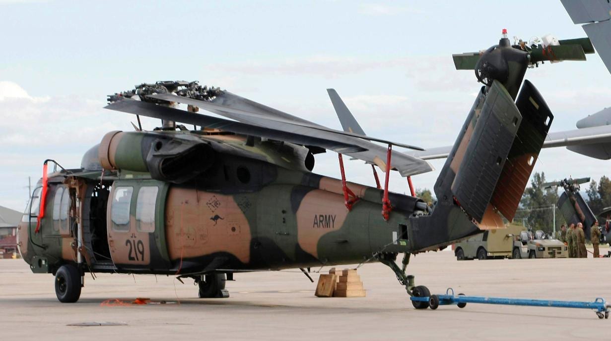 Blackhawk helicopter on tarmac equipped with Davis Aircraft blade fold kit storing the helicopter's blades