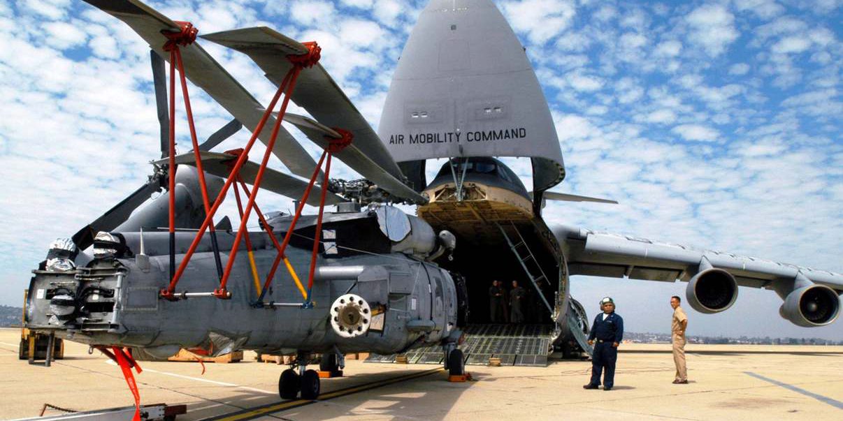 Sikorsky SH-60 helicopter entering into an C-17 Globemaster aircraft equipped with Davis Aircraft's blade fold assembly