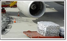 Davis aircraft cargo securing equipment on aircraft runway nearby jumbo jet